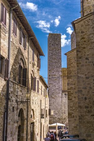 SAN GIMIGNANO, ITALY - APRIL 8, 2018: Unidentified people on the street of San Gimignano, Italy. Historic Centre of San Gimignano is designated as UNESCO World Heritage Site since 1990.のeditorial素材