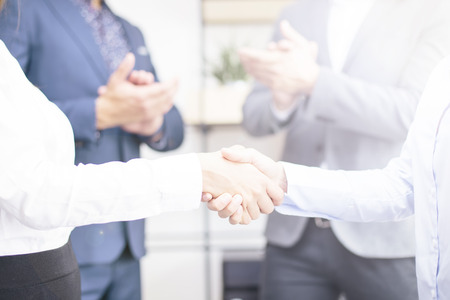 Businesswomen making deal at meeting and handshaking in the office