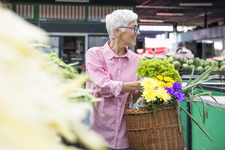 Portrait of senior woman buying on marketの写真素材