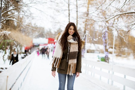Portrait of young woman rides ice skates in the parkの写真素材
