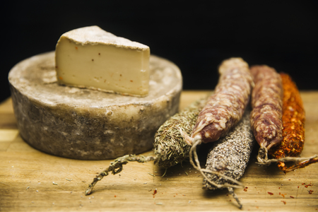 Variety of french dried sausages and cheese from Auvergne on the wooden tableの写真素材