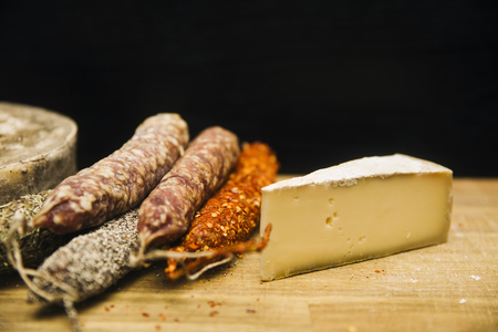 Variety of french dried sausages and cheese from Auvergne on the wooden tableの写真素材
