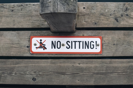 Close up view at no sitting sign on wooden backgroundの写真素材