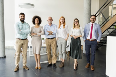 Line of happy and positive business people standing in the officeの写真素材