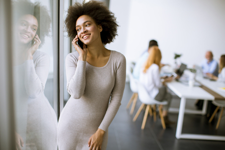 Portrait of a young African American  businesswoman using mobile phoneの写真素材