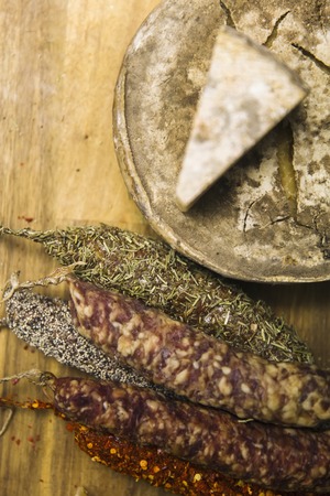 Variety of french dried sausages and cheese from Auvergne on the wooden tableの写真素材