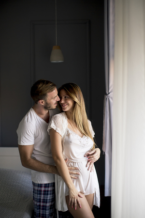 View at loving young couple huging  in the roomの写真素材