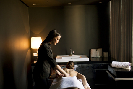 Young woman having a massage in the wellness centerの写真素材