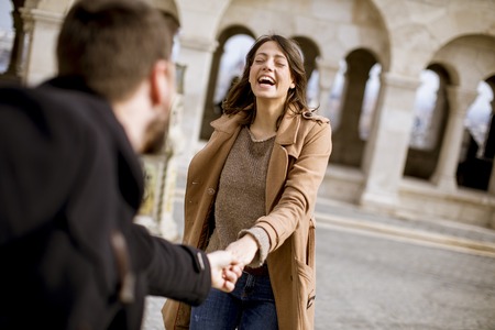 Walk of the pretty loving couple happily walking and holding hands in Budapest, Hungaryの写真素材