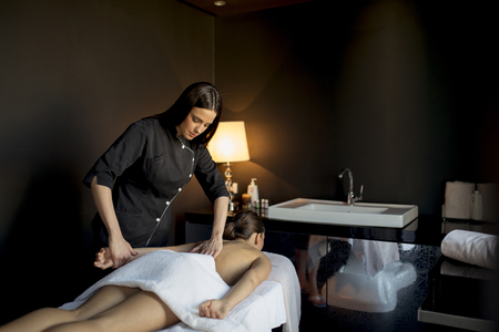 Young woman having a massage in the wellness centerの写真素材
