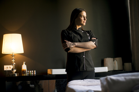 Pretty young therapist in the massage roomの写真素材