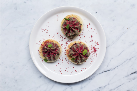 Round chicken liver pate small bites on the plate