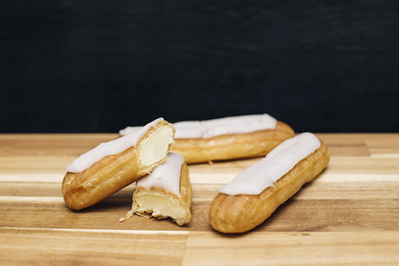 Eclair crispy creamy cake with white chocolate isolated on wooden backgroundの写真素材
