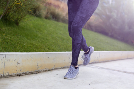 Active young beautiful woman running in urban enviromentの写真素材