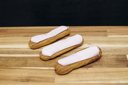 Eclair crispy creamy cake with white chocolate isolated on wooden backgroundの写真素材