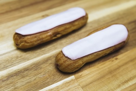 Eclair crispy creamy cake with white chocolate isolated on wooden backgroundの写真素材
