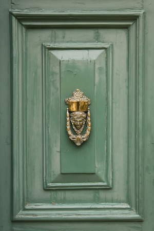 Decorative door knocker on a wooden door from Maltaの写真素材