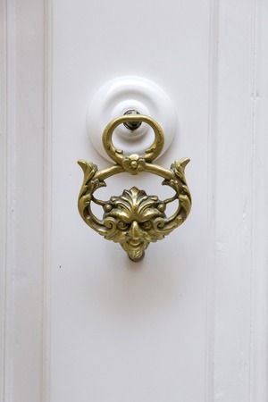 Decorative door knocker on a wooden door from Maltaの写真素材