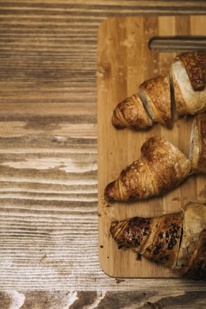 Top view at tasty buttery croissants on old wooden tableの写真素材