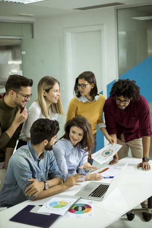 Group of young multiethnic business people working and communicating together in the creative office