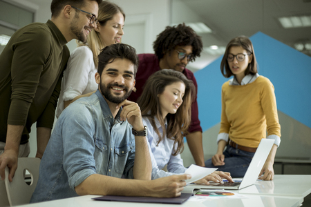 Group of young multiethnic business people working and communicating together in the creative officeの写真素材