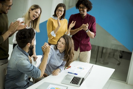 Successful young businesspeople having meeting in modern office space