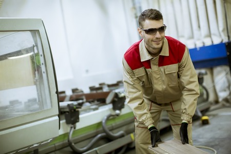 Handsome young man working in the furniture factoryの写真素材