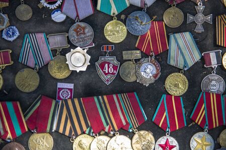 TBILISI, GEORGIA - MAY 3, 2019: Old soviet badges, orders and medals sold on the Dry Bridge Market in Tbilisi, Georgia. It is an everyday open-air flea market.のeditorial素材
