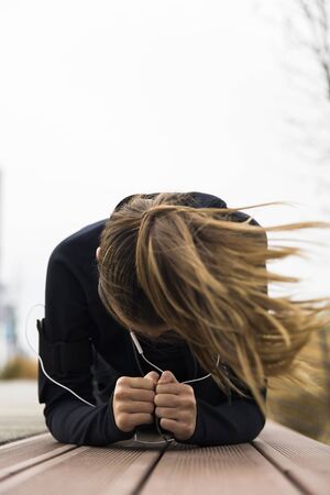 Young woman having an outdoor training on the windy dayの写真素材