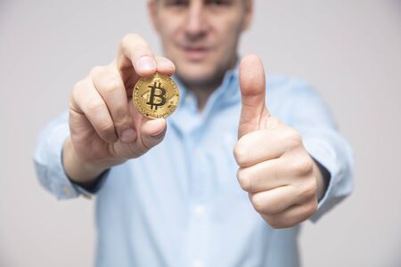 View at businessman offers bitcoin in the handの写真素材