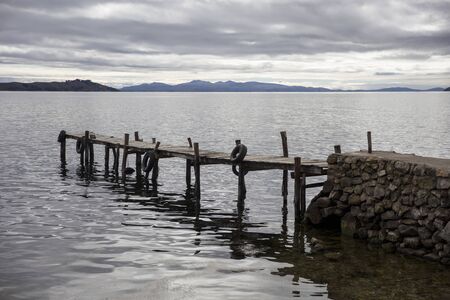 Wooden dock at Isla del Sol on Titicaca lake. It is the biggest island on the high altitude lake Titicacaの写真素材