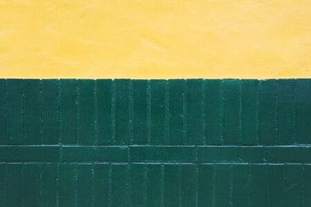 Closeup of the colorful green and yellow wall