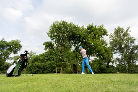 Young man playing on the golf courseの写真素材