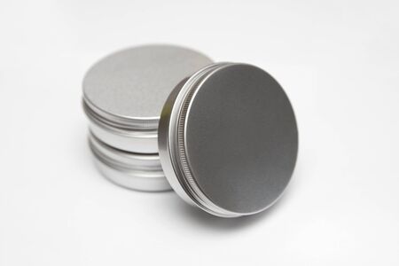 Lip balm in the round metallic tins isolated on the white backgroundの写真素材