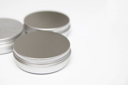 Lip balm in the round metallic tins isolated on the white backgroundの写真素材