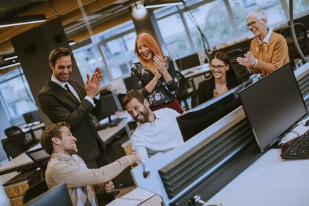 Senior businesswoman and young business people work in the modern officeの写真素材