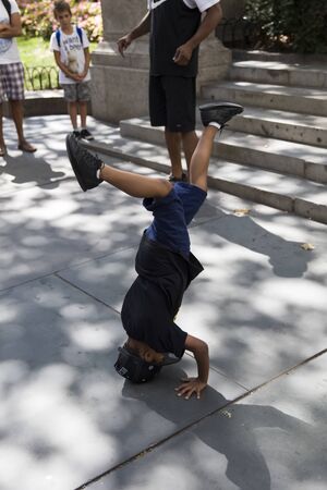 NEW YORK, USA - AUGUST 26, 2017: Unidentified young street performer or busker on the street of New York City. Performing on the streets of New York is legal.のeditorial素材