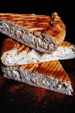 Fresh quiche Lorraine on the dark background