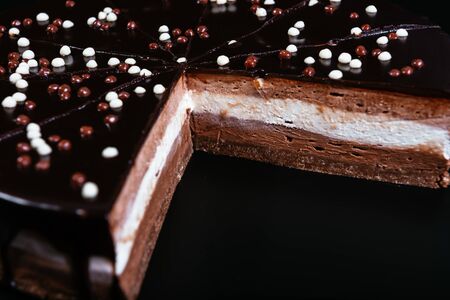 Tart with white, milk and dark chocolate on the dark backgroundの写真素材