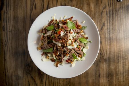 Beefsteak salad with lettuce, rocket,  and spinach with parmesan and 
homemade spicy croutons on...
