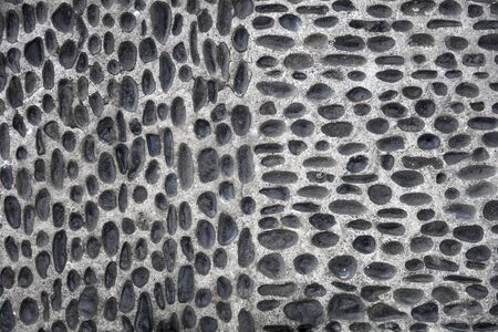 Closeup detail of the pebbles stone road backdropの写真素材