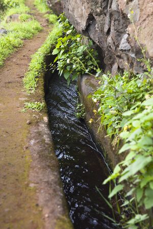 Closeup of the small irrigation channel at the farmlandの写真素材