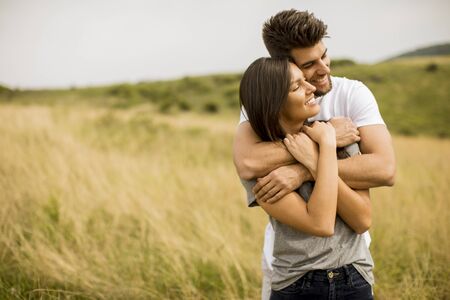 Pretty young couple in love outside in spring natureの写真素材