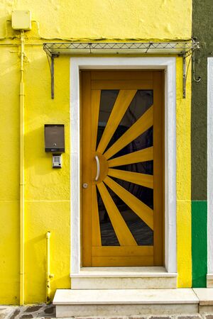 View at old traditional door on colorful building at Burano island, Italyの写真素材