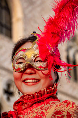 VENICE, ITALY - FEBRUARY 9, 2013: Unidentified woman with Venetian carnival mask in Venice, Italy. At 2013 it is held from January 26th to February 12th.のeditorial素材
