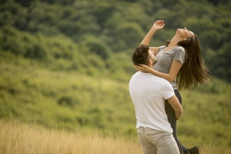 Pretty young couple in love outside in the spring nature