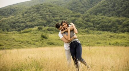Pretty young couple in love outside in the spring natureの写真素材