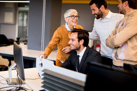 Senior businesswoman working together with young business people in the office
