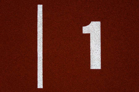 Closeup of the number one on red stadium running track
