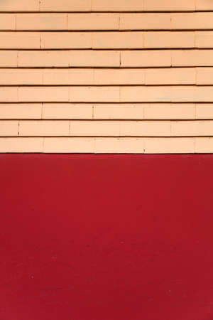 Detail of the red facade with bricks in the upper partの写真素材